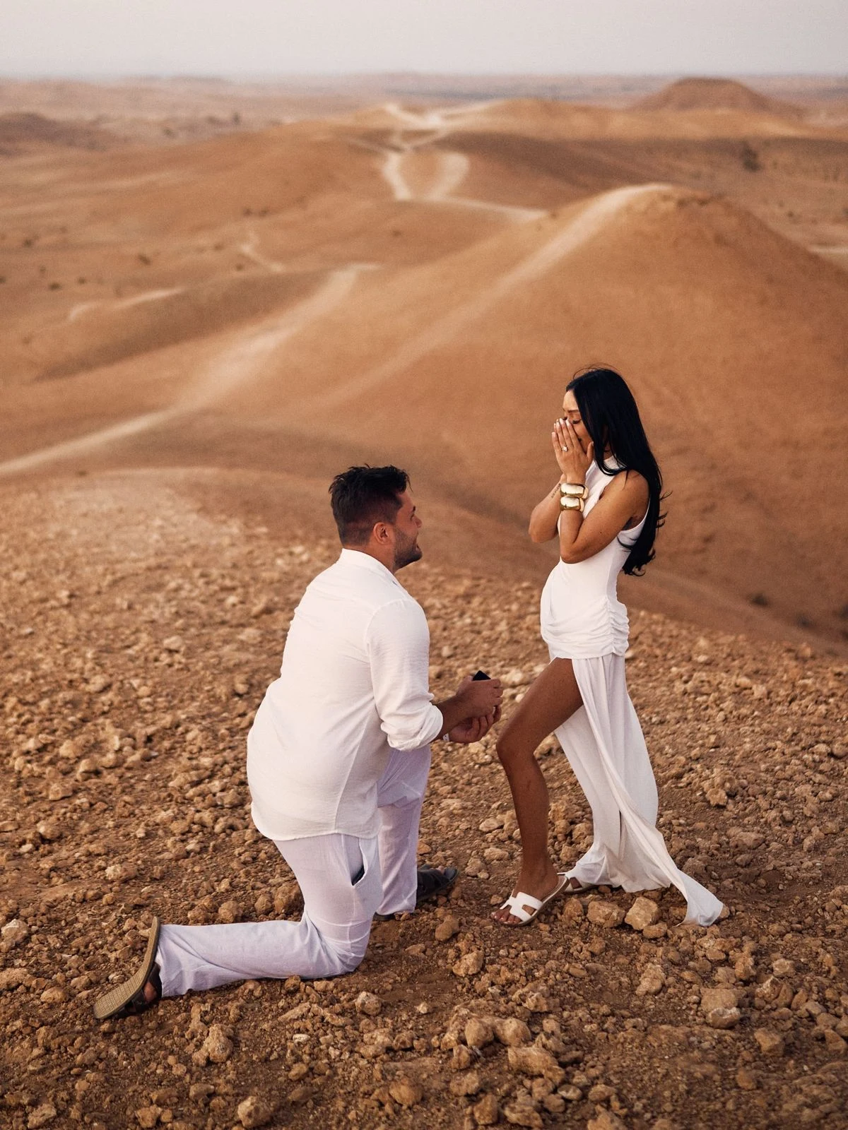 Demande en mariage à genoux dans un paysage désertique